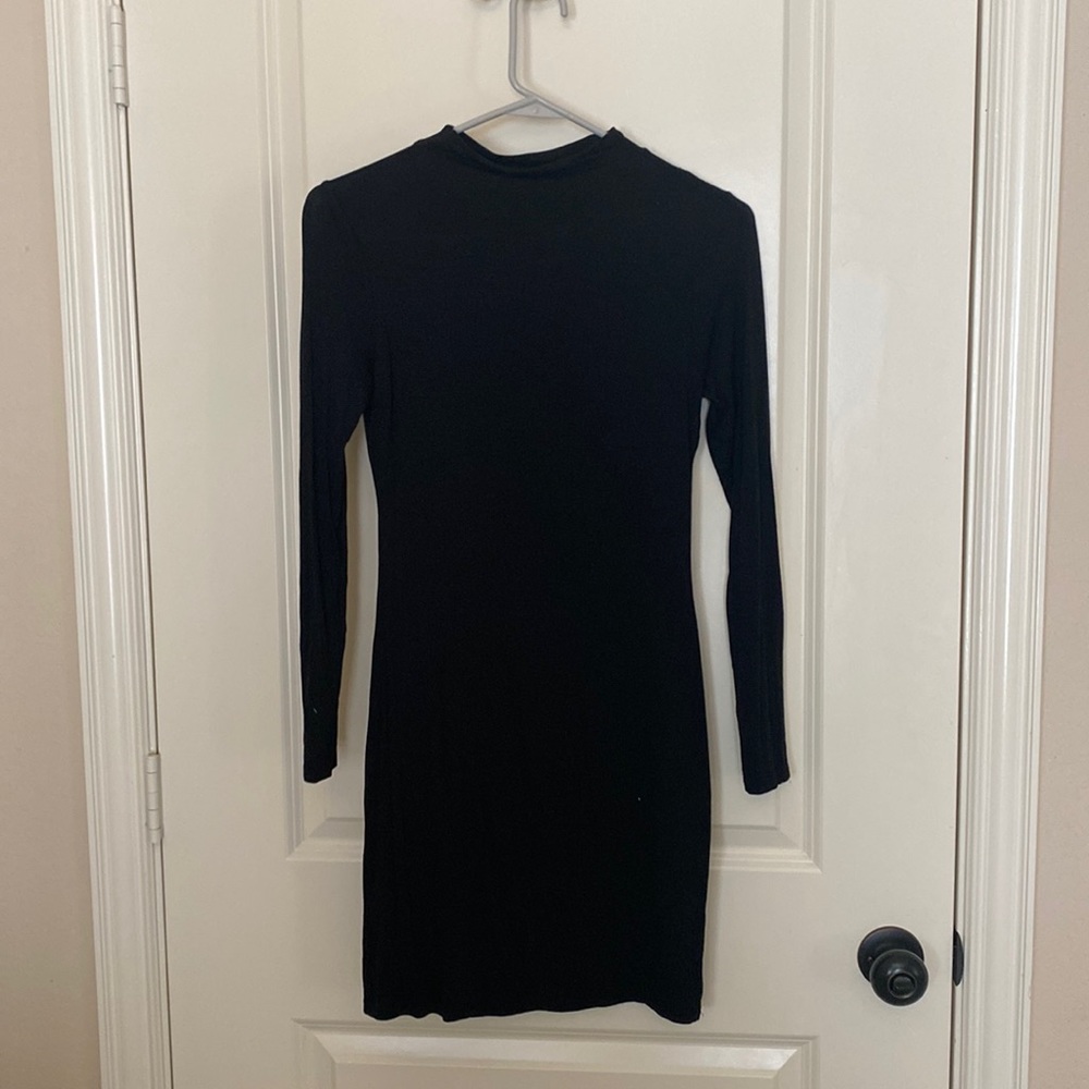 Black long sleeve mini dress. Tight fitting.